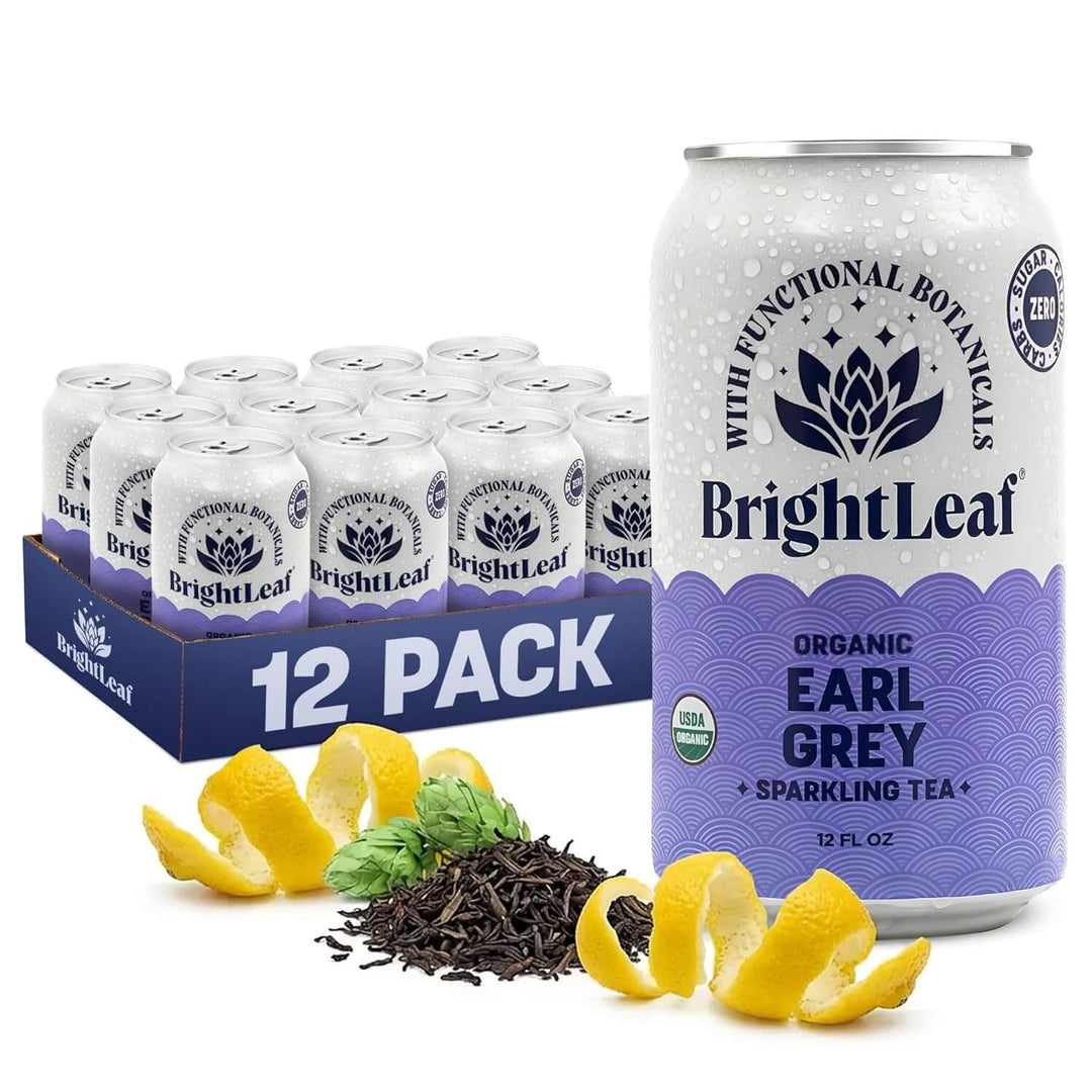 BrightLeaf Organic Earl Grey sparkling tea can and 12-pack box with tea leaves and lemon slices on a white background.